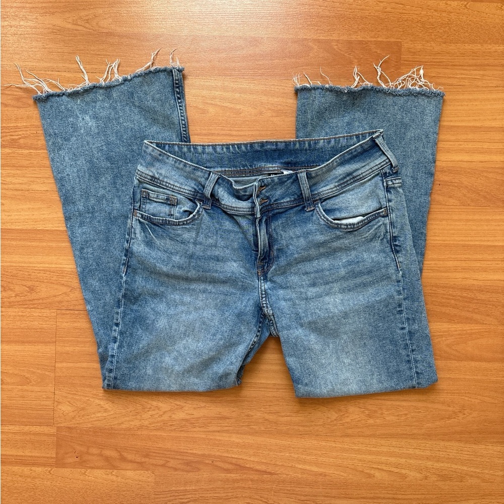 Blue low rise denim jeans with frayed hem